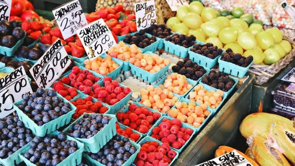 Tips for feeding your family a nutrient dense diet are showcased through an array of fruits and vegetables at a market.