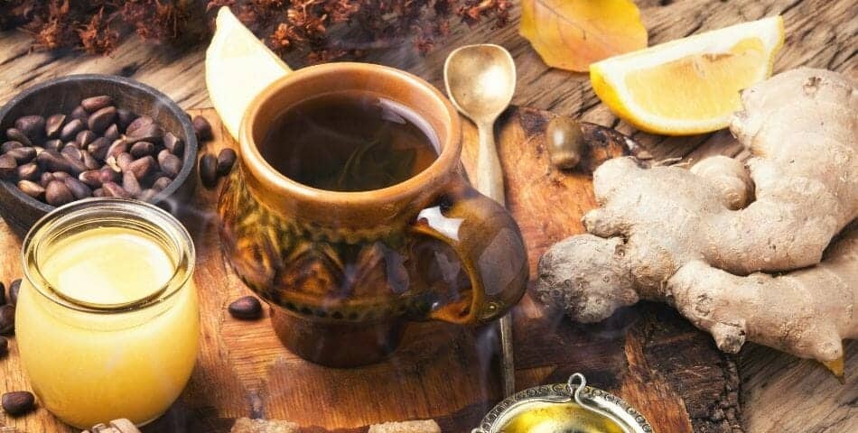 A cup of tea with ginger and lemon, promoting a healthy digestive system.