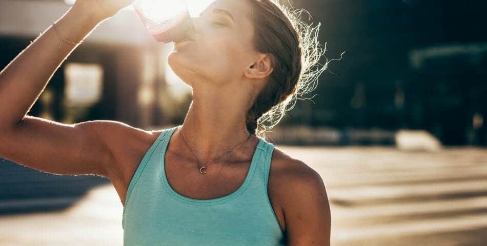Menopause journey aided by proven nutrition foundations while drinking water in the sun.